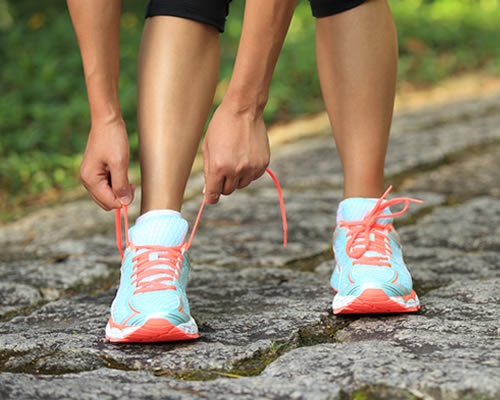 Woman with tying cross trainers