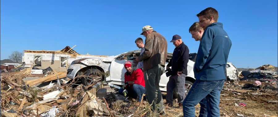 Staff surveying damage.